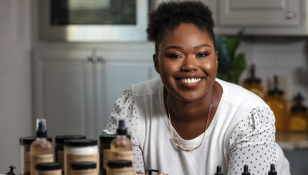 Kelli standing with products from business